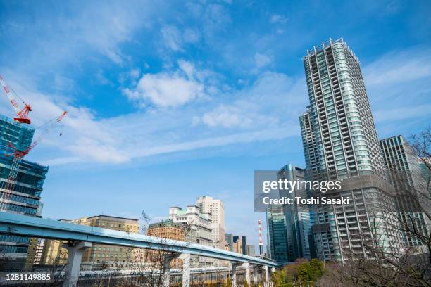 new transit yurikamome runs on elevated railway among the high-rise office buildings at shiodome tokyo japan. - n700s stock pictures, royalty-free photos & images