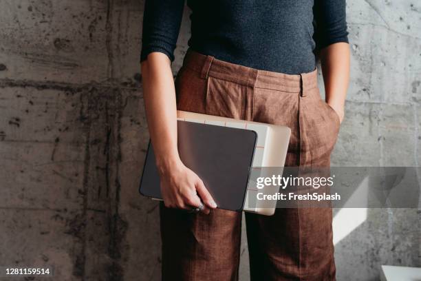 anonieme onderneemster holding bestanden, een laptop en een digitale tablet, een close-up - blank brochure stockfoto's en -beelden