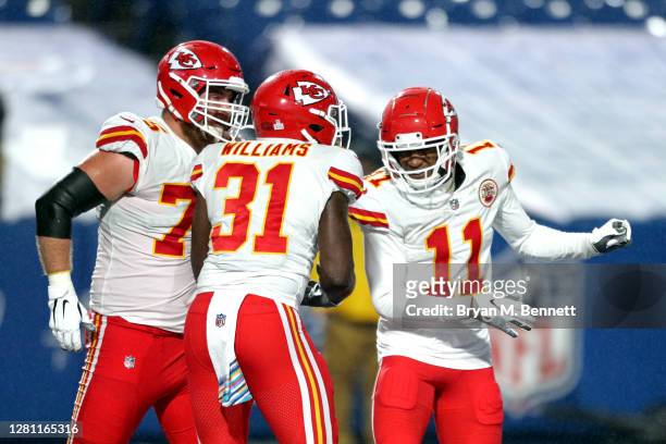 Darrel Williams of the Kansas City Chiefs is congratulated by Demarcus Robinson and Mike Remmers after scoring a thirteen-yard rushing touchdown...