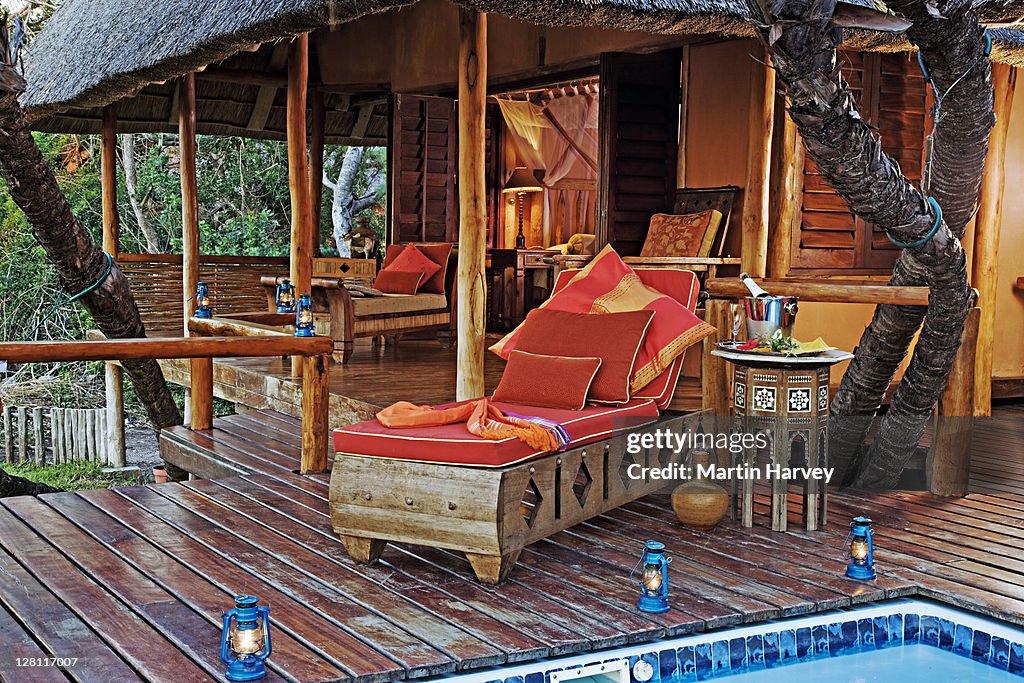 Luxury pool loungers on pool deck of villa. Exclusive luxury accommodation at Benguerra Lodge. Mozambique. (PR: Property released).