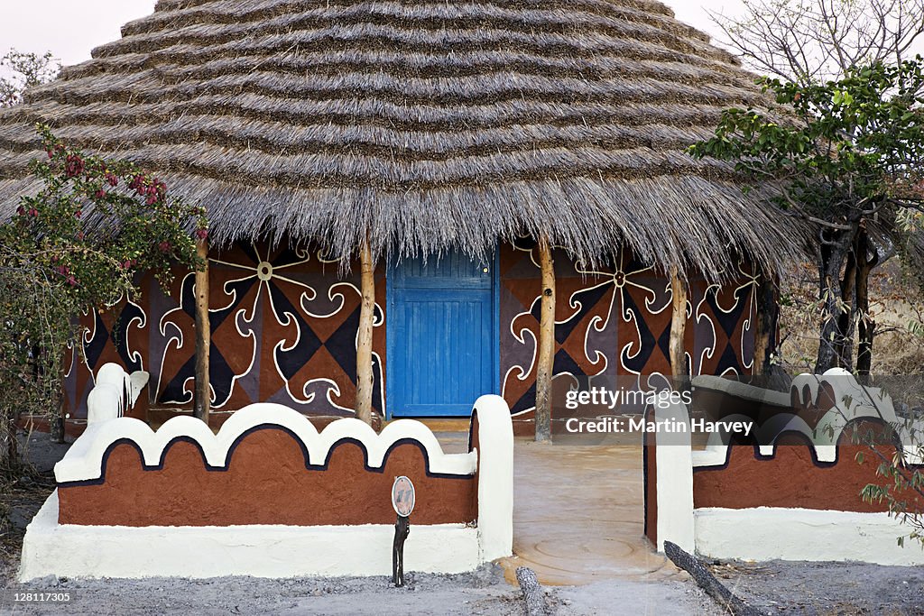 Thatched hut painted with traditionally styled Bakalanga decorative designs. Planet Baobab, Botswana. (PR: Property Released)