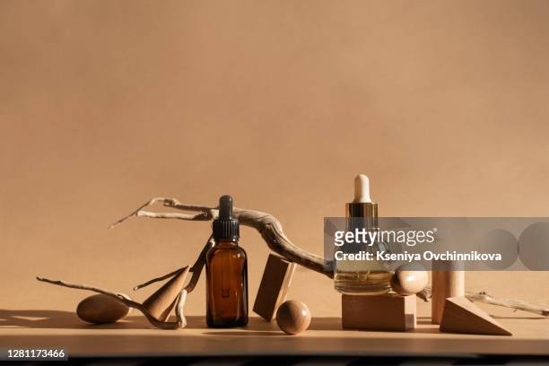 composition with bottles of essential oils on table. natural cosmetics - brown bottle stock pictures, royalty-free photos & images