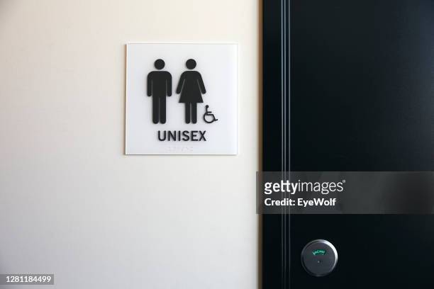 a unisex bathroom entrance. - restroom sign stock-fotos und bilder