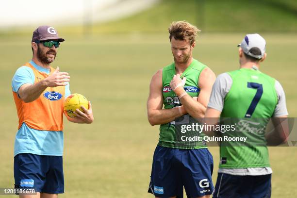 Matthew Scarlett the assistant coach of the Cats talks to Lachie Henderson and Harry Taylor of the Cats during a Geelong Cats AFL media opportunity...