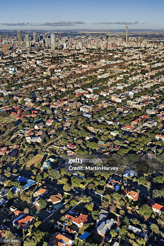 Extensive aerial view over Johannesburg city center showing all the highrise buildings and treelined suburbs surrounding it. Gauteng Province, South Africa.