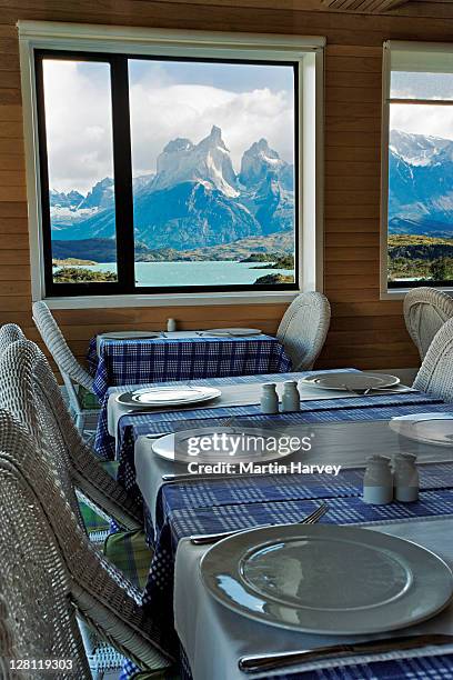 view of los cuernos from the dining room window at hotel explora. torres del paine national park. chile. - explora park stock pictures, royalty-free photos & images