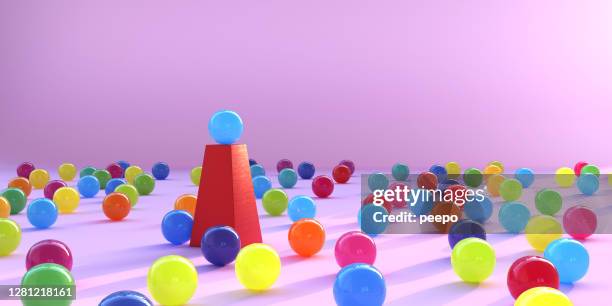 multi coloured spheres surrounding a single sphere on a plinth - surrounding support stock pictures, royalty-free photos & images