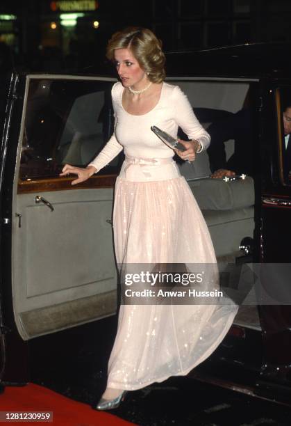 Diana, Princess of Wales, wearing a floor length peach dress, arrives to attend a charity performance of Andrew Lloyd Webber's 'Starlight Express' at...