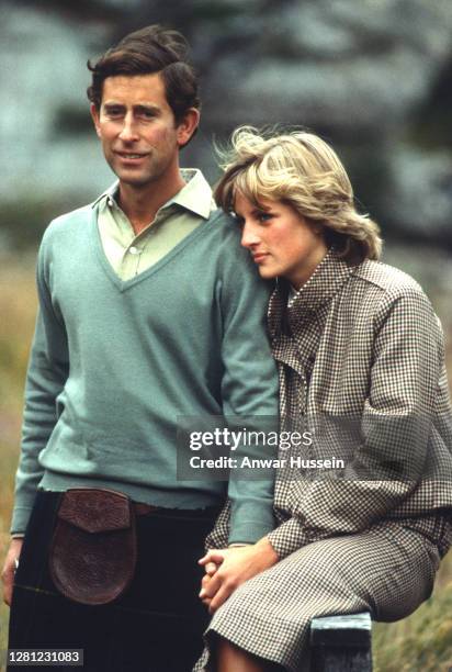 Prince Charles, Prince of Wales and Diana, Princess of Wales, wearing a suit designed by Bill Pashley, pose for a photo on the banks of the river Dee...