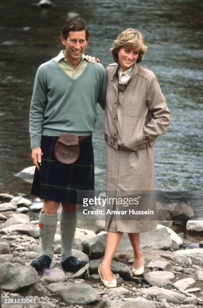 Prince Charles, Prince of Wales and Diana, Princess of Wales, wearing a suit designed by Bill Pashley, pose for a photo on the banks of the river Dee...