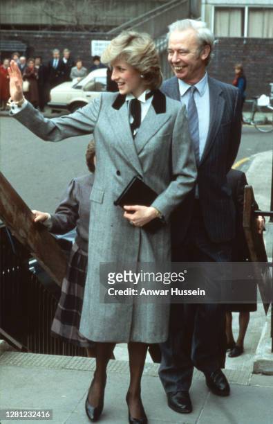 Diana, Princess of Wales, wearing a grey Herringbone coat with a velvet collar designed by Jan Van Velden and a 'Teddy Bow' style bow tied round her...