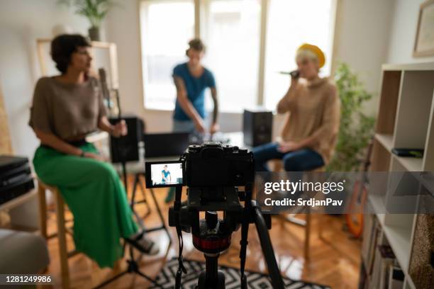 performance group recording video for their new song in the music studio - woman in guitar making studio stock pictures, royalty-free photos & images