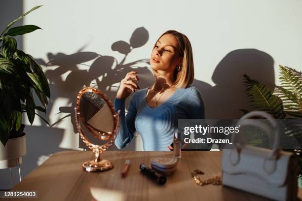 gen z woman at home, putting make up on before going on date - parfum stock pictures, royalty-free photos & images