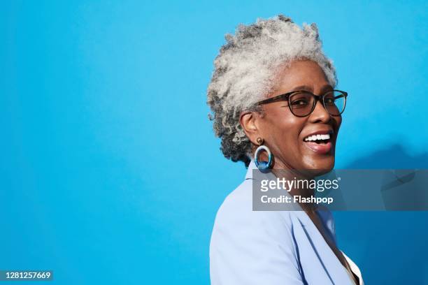 portrait of a confident, successful, happy mature woman - senior studio portrait stockfoto's en -beelden