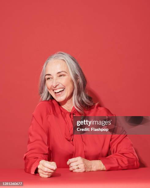 portrait of a confident, successful, happy mature woman - red and white people stock pictures, royalty-free photos & images