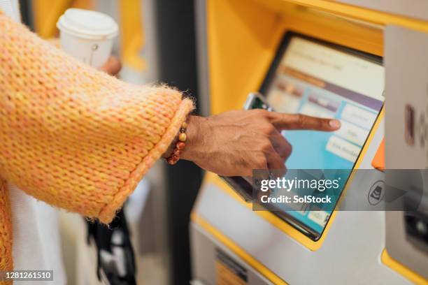 unrecognisable man using ticket machine - train ticket stock pictures, royalty-free photos & images