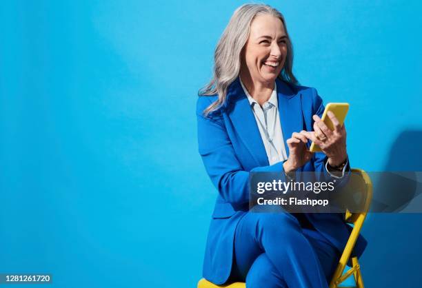 portrait of a confident, successful, happy mature woman - business woman blue stockfoto's en -beelden