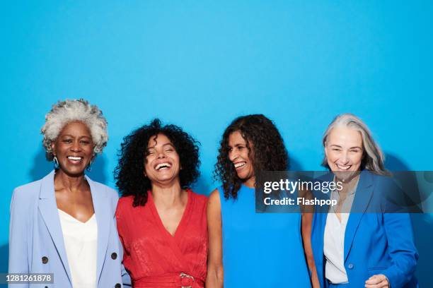 portrait of a group of mature women against a blue background - black woman happy white background stock pictures, royalty-free photos & images