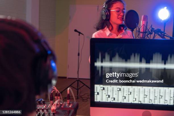 female vocalist in recording studio - radio dj booth stock pictures, royalty-free photos & images