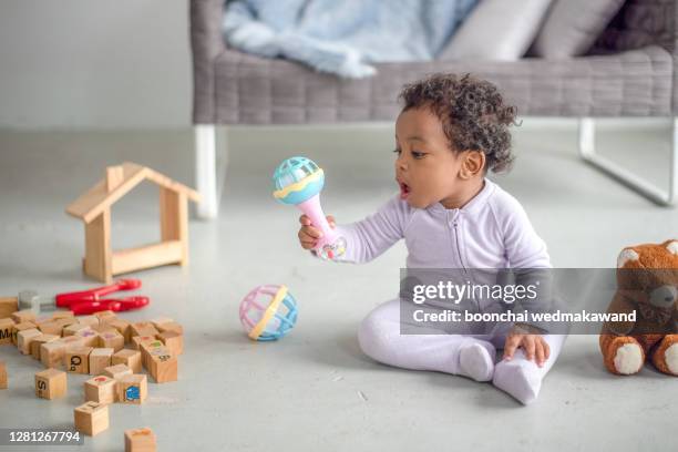 cute little boy playing with a railroad train toy - six month old stock pictures, royalty-free photos & images