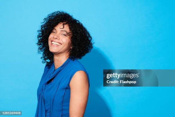 portrait of a confident, successful, happy mature woman - woman on coloured background stock pictures, royalty-free photos & images