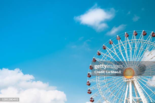 ferris wheel with blue sky in okinawa japan. - amusement park sky fotografías e imágenes de stock