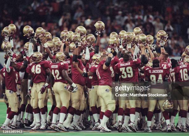 Players for the Florida State Seminoles raise their helmets in celebration after winning the NCAA Nokia Sugar Bowl Championship Series National...