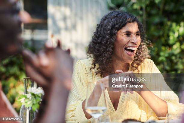 friends talking and dining outside on a warm summers day. - summer women talking stockfoto's en -beelden