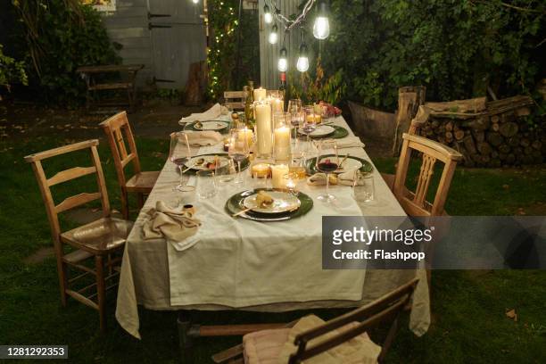 still life of a dressed dining table set for six people - garden night photos et images de collection