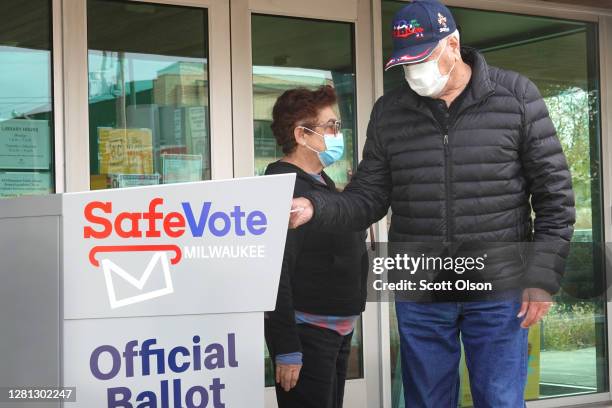 Residents drop mail-in ballots in an official ballot box outside of the Tippecanoe branch library on October 20, 2020 in Milwaukee, Wisconsin. Today...