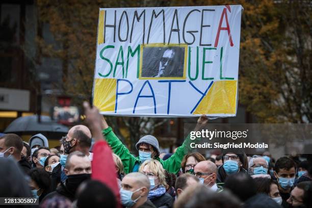 Locals pay tribute to Samuel Paty, the teacher beheaded last week outside the school where he taught, in the Paris suburb of...