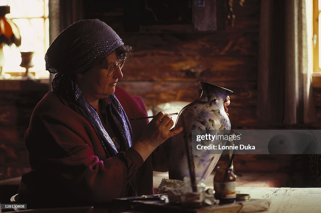 Woman painting ceramics