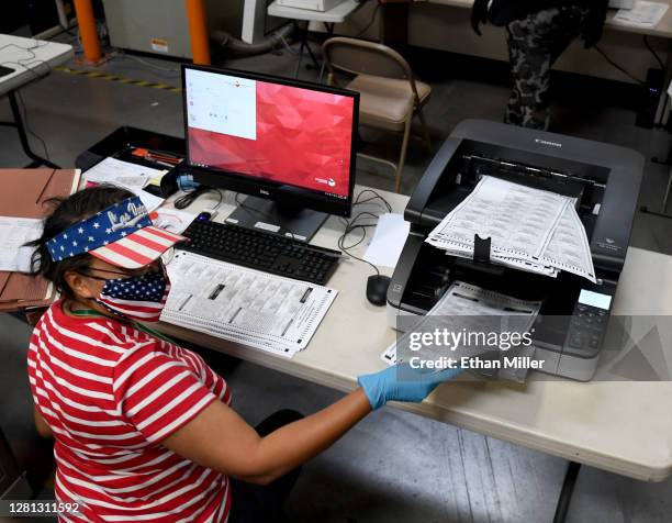 Clark County election worker scans mail-in ballots at the Clark County Election Department on October 20, 2020 in North Las Vegas, Nevada. In-person...