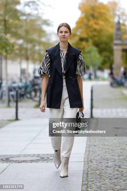 Influencer Jacqueline Zelwis, wearing a black vest by Brigitte Herskind, a beige and black zebra print blouse by Sezane, cream colored pants by...