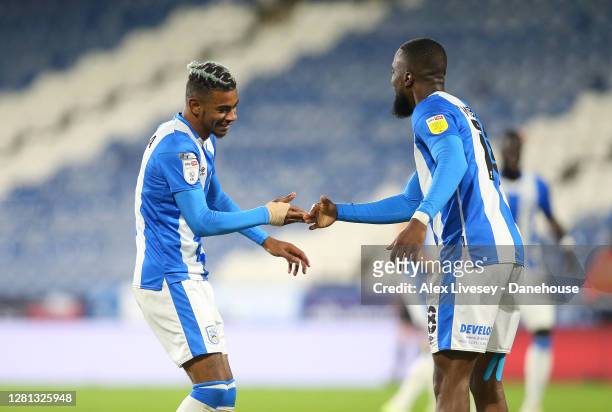 Juninho Bacuna of Huddersfield Town celebrates with Isaac Mbenza after scoring the opening goal during the Sky Bet Championship match between...