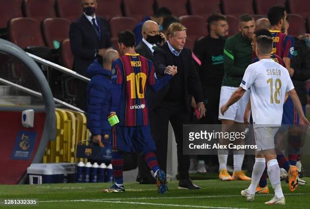 Lionel Messi of FC Barcelona and Ronald Koeman, Head Coach of FC Barcelona interact following their sides victory in the UEFA Champions League Group...