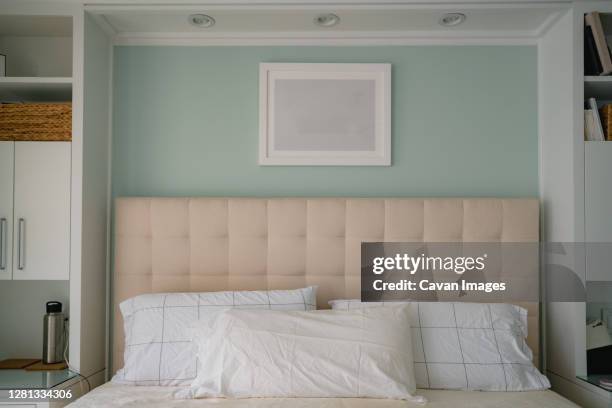 headboard and custom built in shelving in clean modern bedroom - headboard stock pictures, royalty-free photos & images