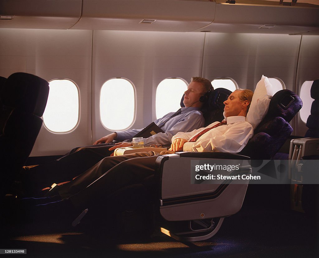 Executives relaxing during flight