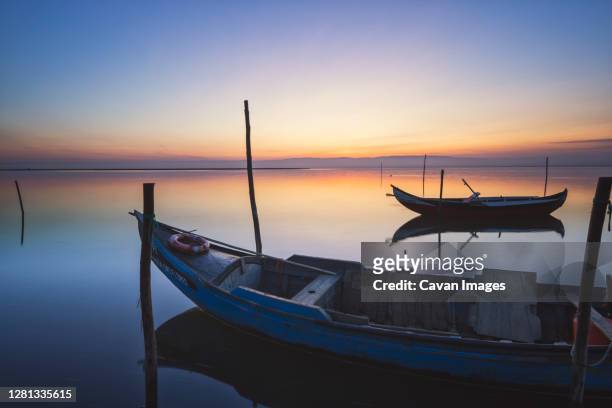 wooden boats at sunset with the sea in calm - estuario photos et images de collection
