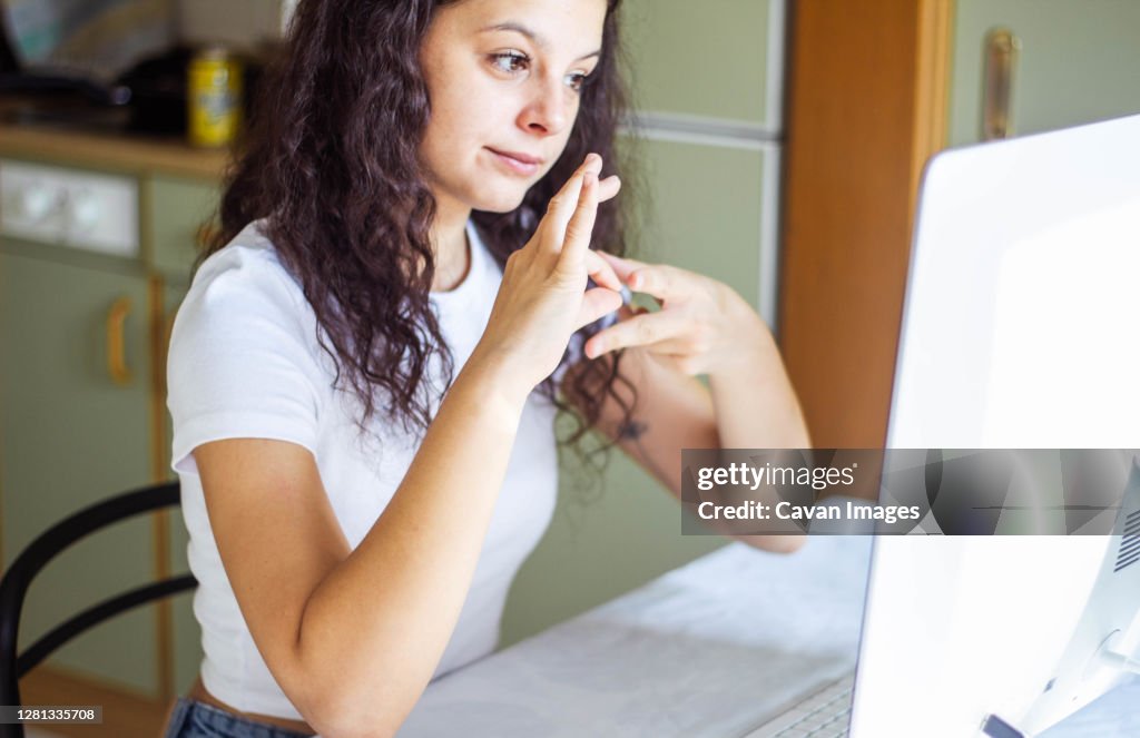 Girl speaking sign language on video call