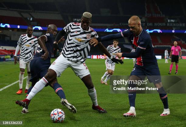 Paul Pogba of Manchester United in action with Danilo Pereira and Mitchel Bakker of Paris Saint-Germain during the UEFA Champions League Group H...