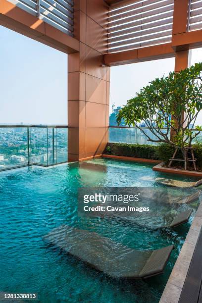 rooftop swimming pool at luxury condominium in bangkok - rooftop pool stock pictures, royalty-free photos & images