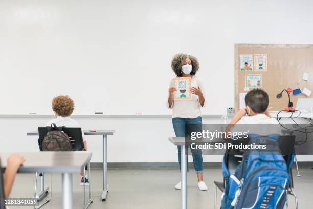 teacher teaches class during covid-19 - bulletin board flyer stock pictures, royalty-free photos & images