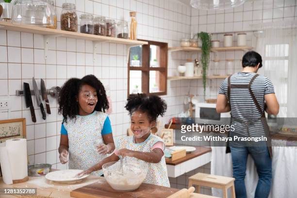 happy family funny kids bake cookies in kitchen - happy dirty child stockfoto's en -beelden