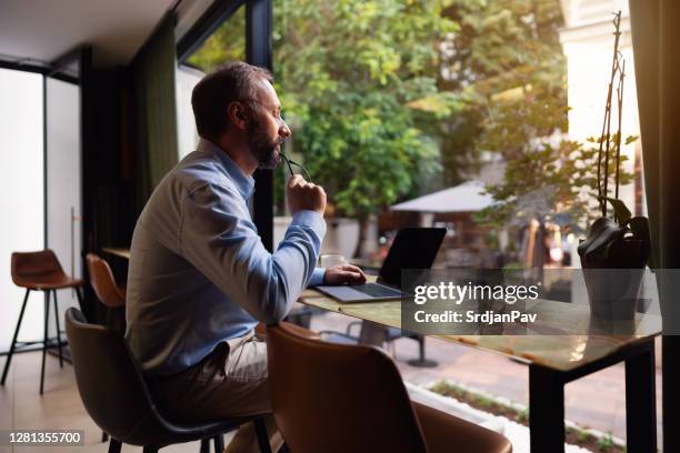 freelancer  thinking about job and using laptop at the coffee shop - project manager stock pictures, royalty-free photos & images