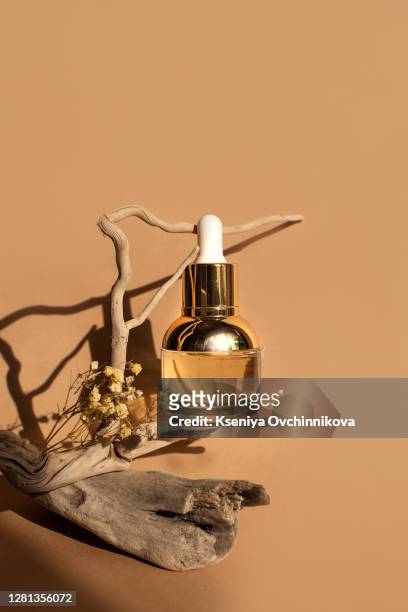 composition with bottles of essential oils on table. natural cosmetics - room plant stockfoto's en -beelden
