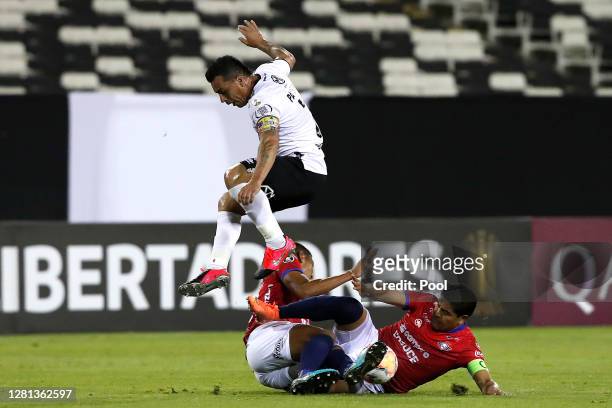 Esteban Paredes of Colo Colo competes for the ball with Edward Zenteno and Ronny Montero of Jorge Wilstermann during a Group C match of Copa CONMEBOL...