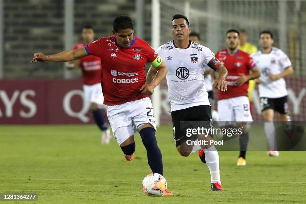 Edward Zenteno of Jorge Wilstermann competes for the ball with Esteban Paredes of Colo Colo during a Group C match of Copa CONMEBOL Libertadores 2020...