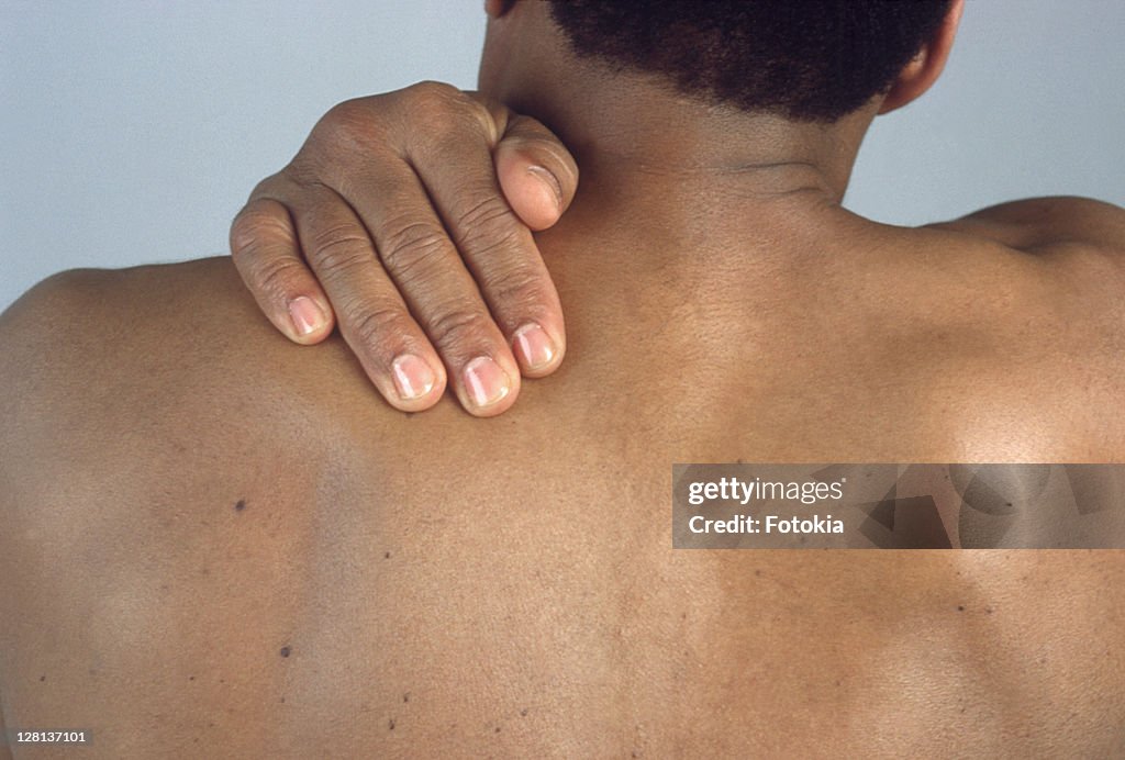 Man massaging his shoulder blade