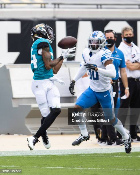 Keelan Cole of the Jacksonville Jaguars catches a pass against Jeff Okudah of the Detroit Lions during the second half of a game at TIAA Bank Field...